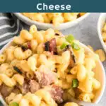 Bowl of bacon Mac and cheese garnished with green onion.