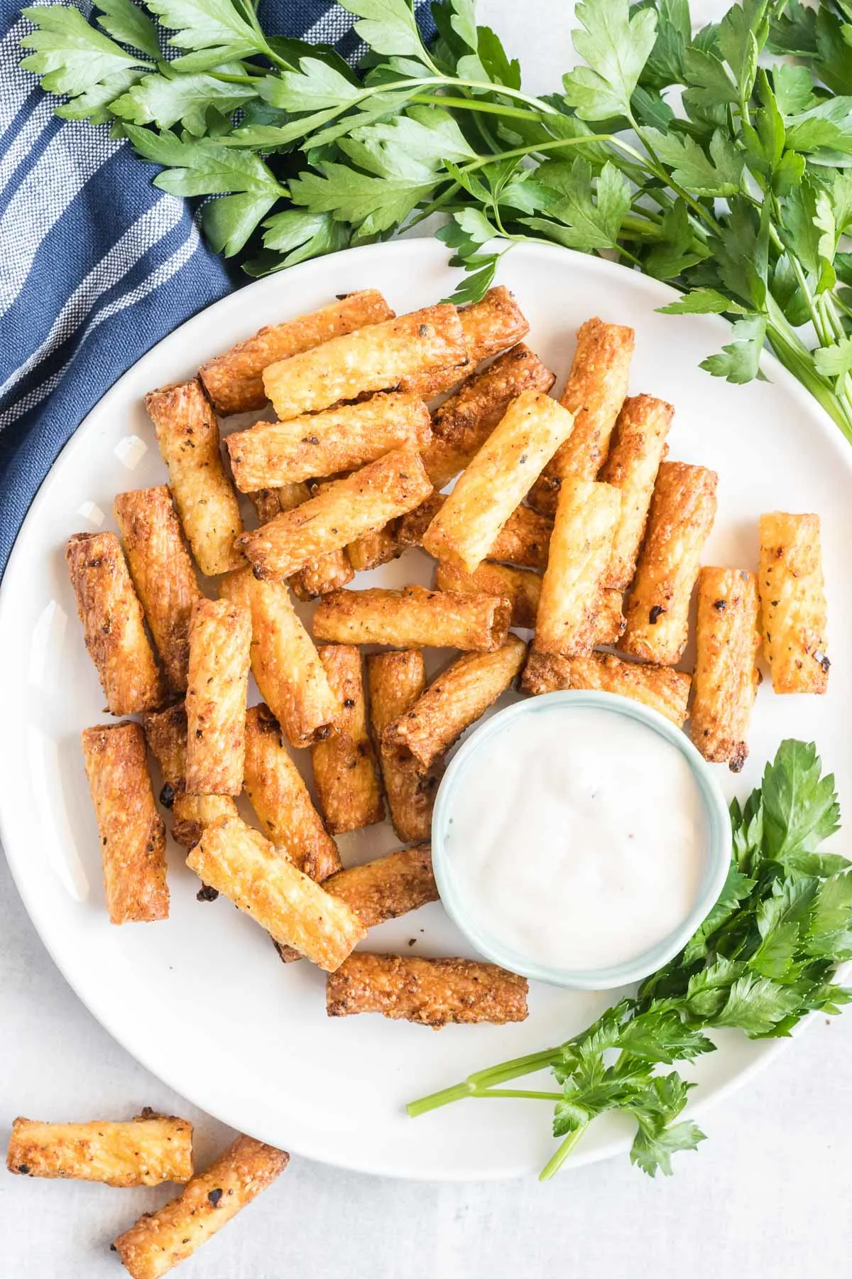 Crispy pasta noodles on a plate with dipping sauce on the side. 