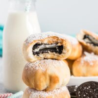 Air fried oreos in a stack with a bite out of the top oreo.