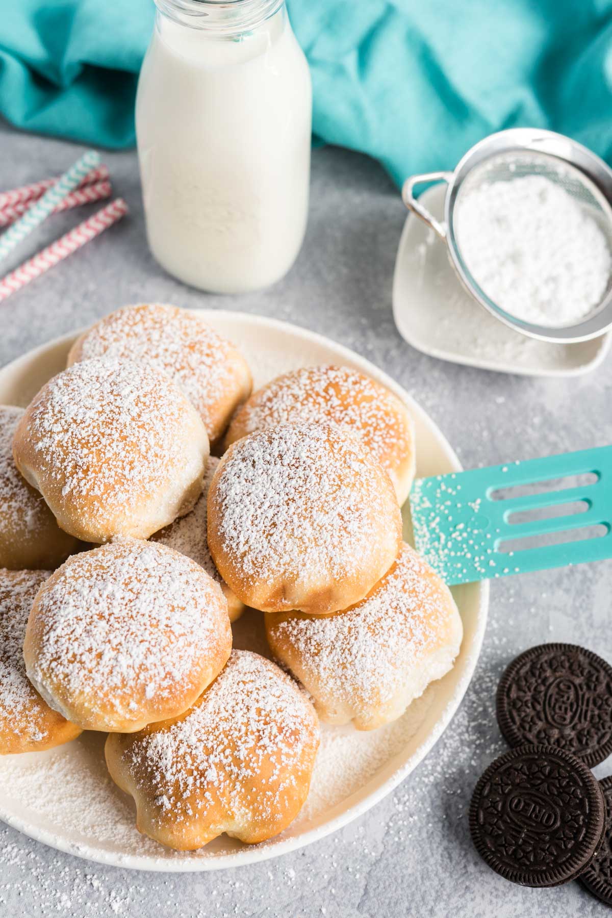 A plate of air fried Oreos with a glass of milk.