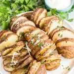 Spiral potatoes on a plate with a dish of ranch dip.