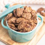 Candied pecans in a small blue bowl.