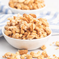 Coconut cashew clusters in a small white bowl.