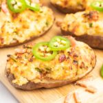 Twice baked potatoes topped with jalapeño slices and chopped bacon.