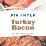 Cooked turkey bacon in an air fryer basket and a serving plate.