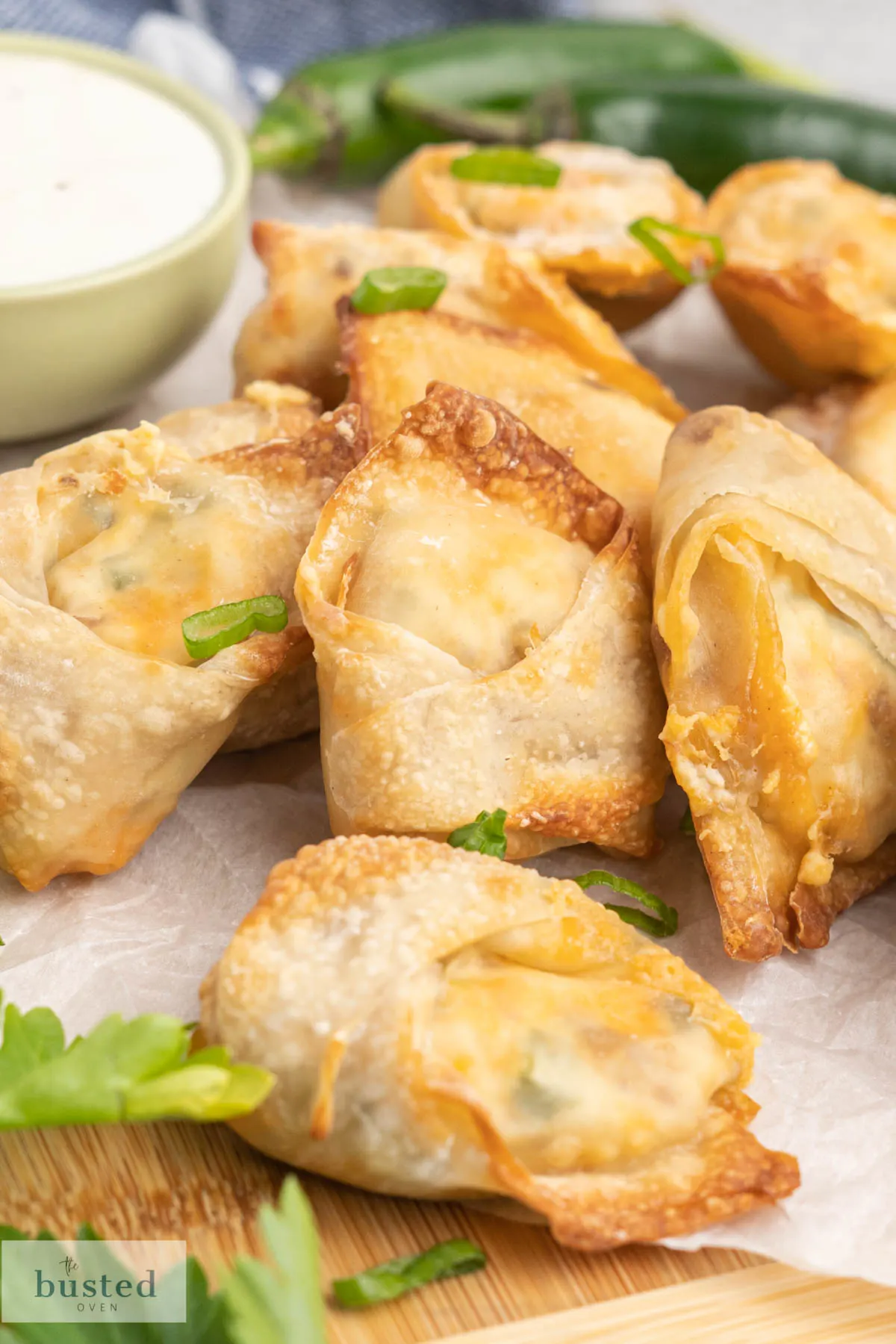 A platter of crispy wontons sprinkled with green onion.